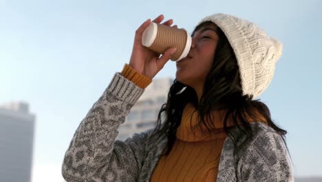 Woman-enjoying-hot-drink-on-winters-day