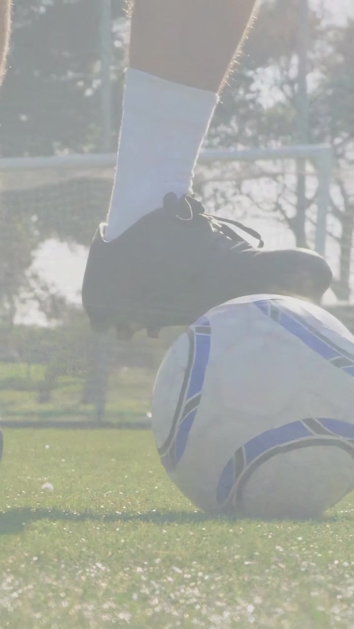 Video vertical: Jugador de fútbol pisando el balón, controlándolo y rodándolo hacia la portería durante un entrenamiento.