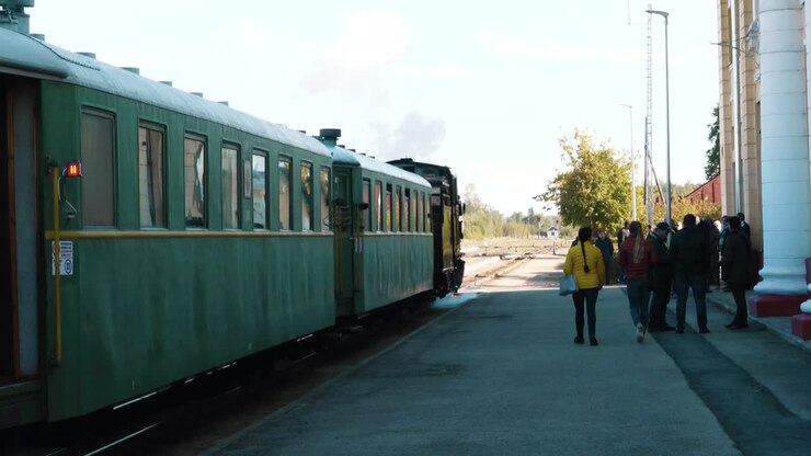The old train travels on the railway tracks