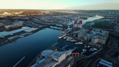 boats at ferry terminal by gota alv river near lilla bommen and bridge at gothenburg, sweden