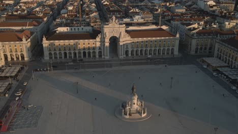 areal drone footage of the historical center praca do comercio town square in lisbon, portugal, filmed during sunset