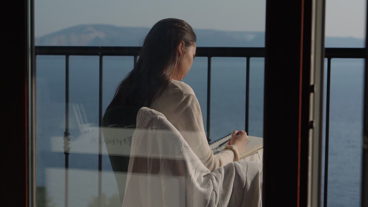 Woman Drawing on a Balcony with a Sea View
