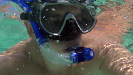 young man making underwater selfie