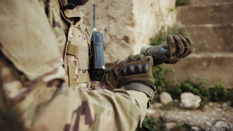hands of a soldier putting on gloves before battle