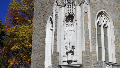 gothic windows and statue of george washington on bell tower.  autumn trees in background