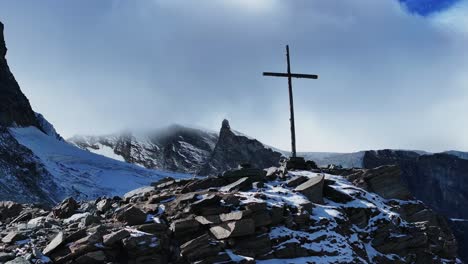 cerca cristiano católico religioso jesús cristo cruzar rocoso glaciar cima de la montaña drone aéreo saas tarifa alpes suizos suiza otoño cielo azul soleado mediodía capa nublada círculo delantero