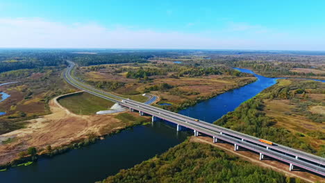 birds eye view of highway road over river. aerial view road bridge over water