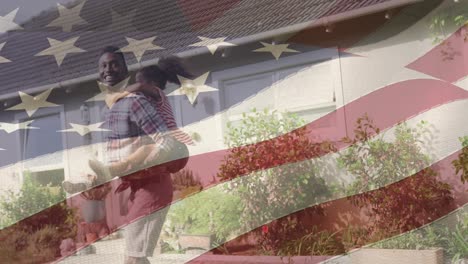 animation of flag of united states of america over african american father and daughter having fun