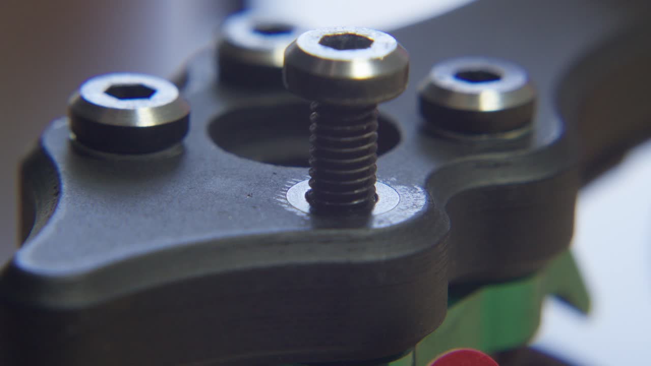 Carbon Fiber Arm Screws on Drone Frame Being Unscrewed With Tool During Assembly