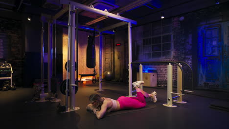 Strong woman doing gluteal exercises lying face down on a mat