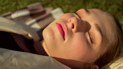 woman relaxing outdoors with leaves