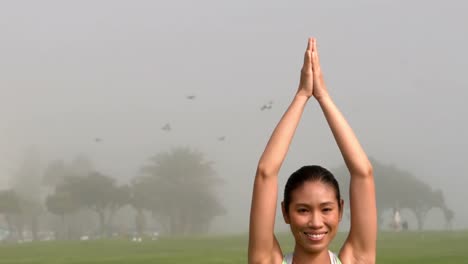 smiling sporty woman doing yoga