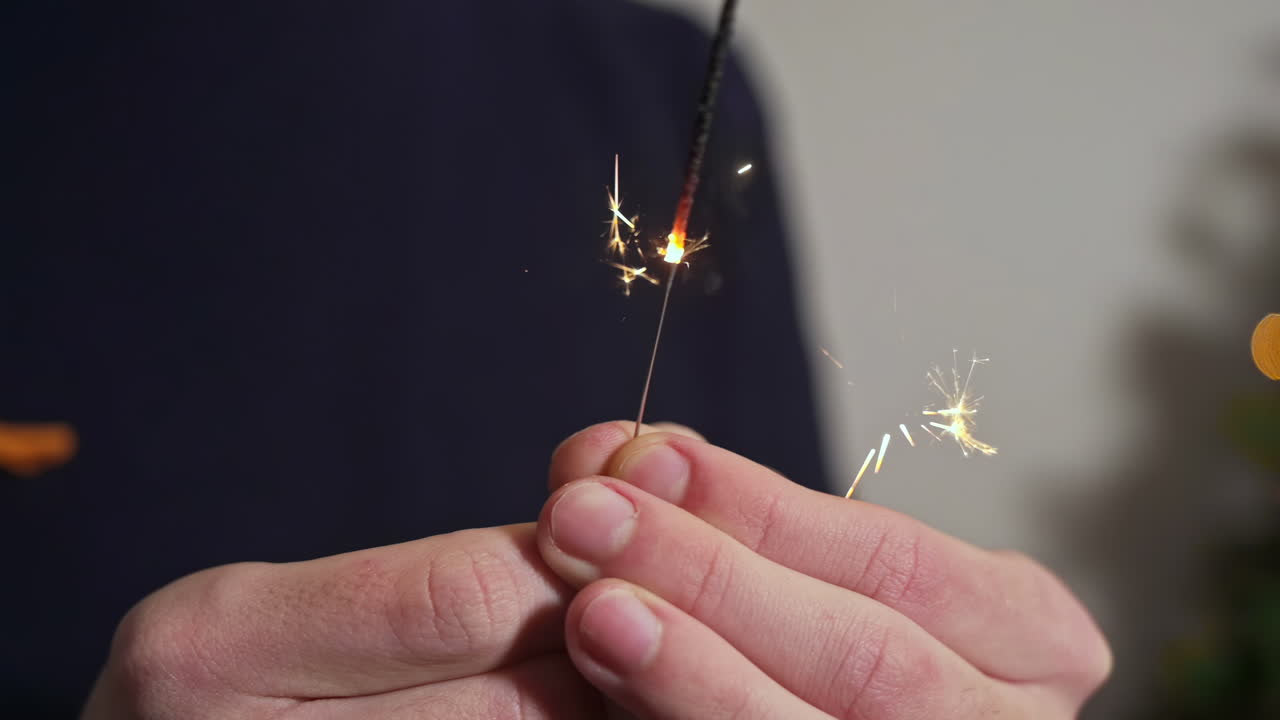 Sparklers stewing in young man's hands