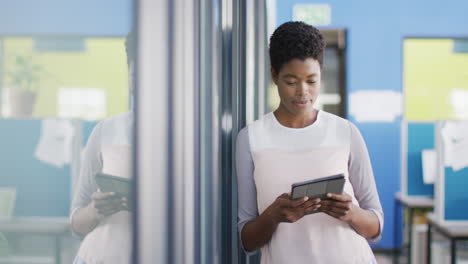 Portrait of african american businesswoman using tablet at office, copy space, slow motion