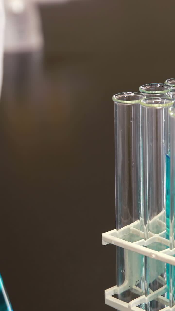 Young scientist using pipette to put chemical in test tube