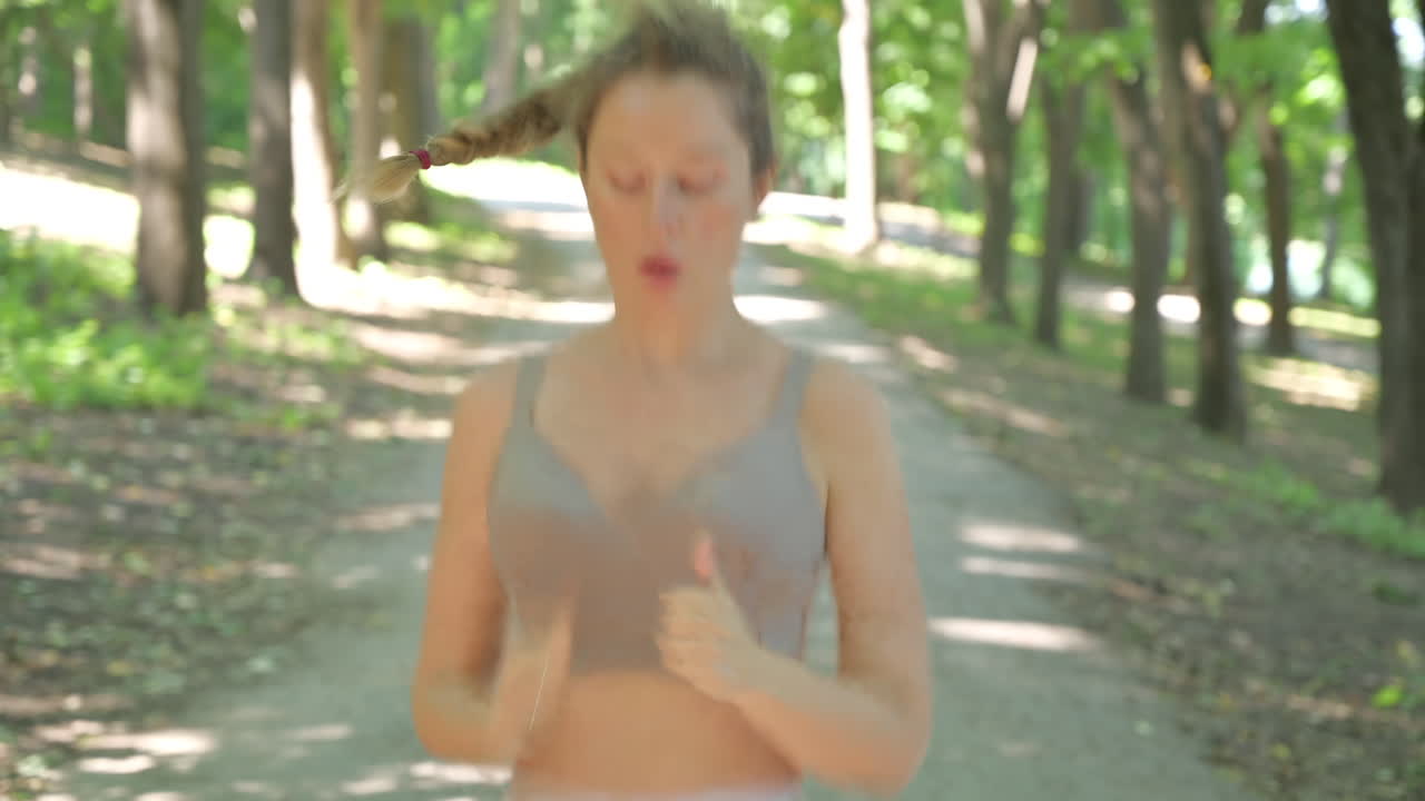 Woman in beige sportswear working out in the park
