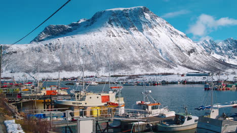 Stunning-cinematic-tracking-shot-of-fishing-boats-in-Tromvik-harbour,-Norway