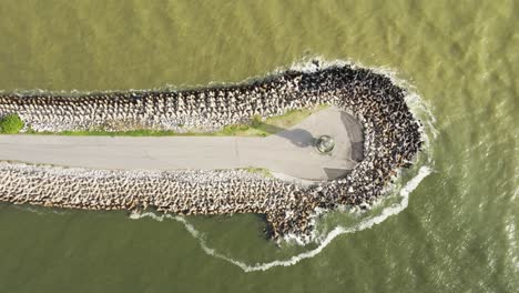 Top-aerial-view-from-above-of-the-lighthouse-of-Farol-Do-Molhe-Da-Barra-De-Itajai,-Santa-Catarina,-Brazil,-at-sunrise