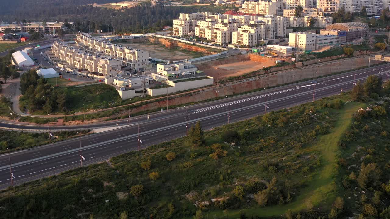 Aerial View of Modern Residential Buildings, Highway, and Forest