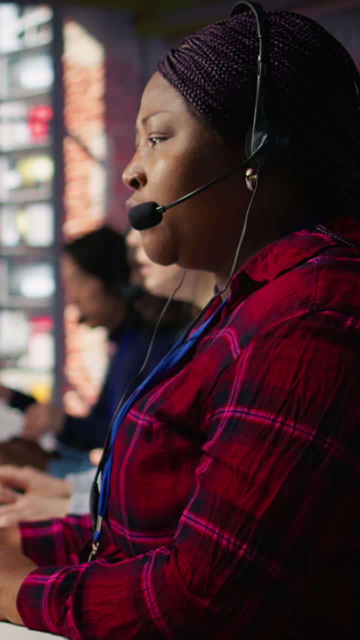 Vertical video IT support expert in call center troubleshoots errors to minimize downtime