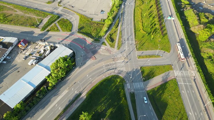 Aerial shot of intersection in suburb area of Gdansk and parking place during sunlight,Poland
