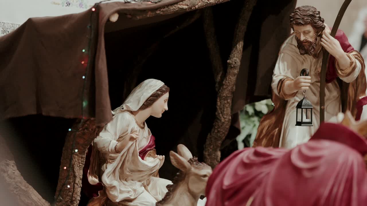 Close view of nativity figurines with Mary Joseph donkey and lantern
