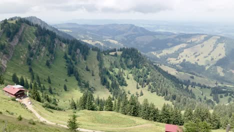 Top-view-onto-mountains-and-small-shelter-in-the-distance