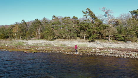 Aerial-sweeping-man-fishing-fisher-fisherman-lake-ocean-throw-reel-feeling-salmon-hook-waters-bait-trolling-fiber-glass-rods-old-man-relaxing-beach-steelhead-sushi-angler-trawler-catch-sailboat-nature