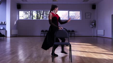 Professional-female-dancer-dances-around-two-chairs