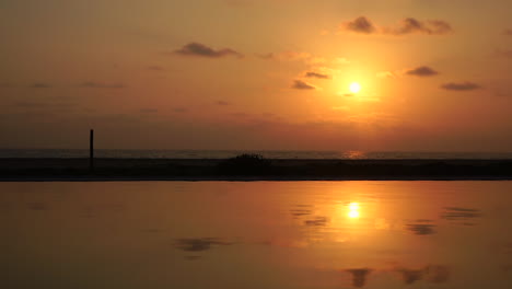 Moving-water-reflection-with-the-beautiful-sunset-time-from-the-ocean-and-beautiful-clouds-sky-in-the-evening-time