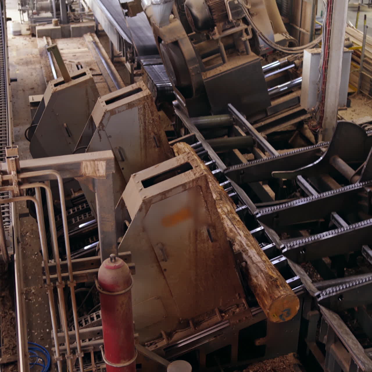 Industrial background of a woodworking plant. Working process of automated equipment on the modern power-saw bench.