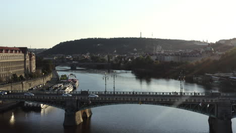 aerial shot of bridge over vltava river and prague castle at sunset, czech republic