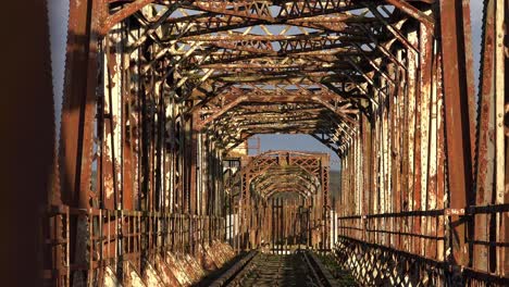 Old-disused-railway-bridge,-rusty-steel-and-industrial-heritage