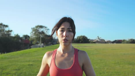 Front-of-Eurasian-female-as-she-runs-through-the-park