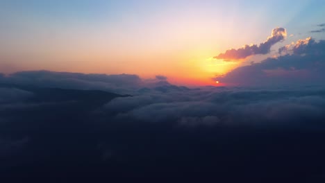 flying over the clouds with the late sun. sunrise or sunset colorful sky background.