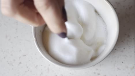 adding cream to the morning coffee