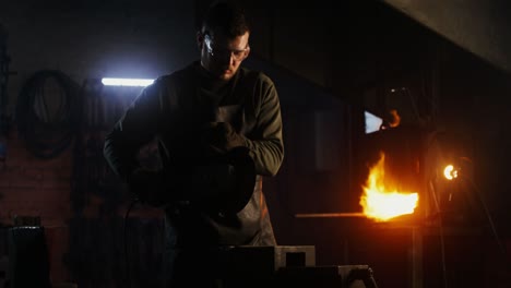 metalworker grinding metal pipe in a workshop