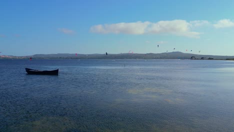 Scenic-drone-shot-of-Kite-surfing-at-Punta-Trettu-beach,-San-Giovanni-Suergiu,-South-Sardinia,-Italy