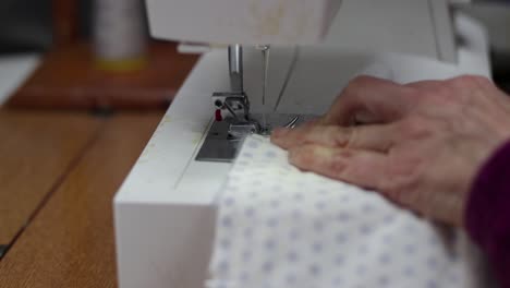 seamstress engaged in manufacture of covid19 protective mask. close up