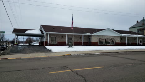 small town funeral home in winter with snow