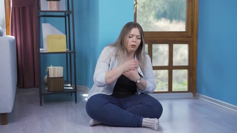 sick young woman coughing leaning against wall. hopeless.