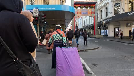 people crossing street in melbourne's chinatown