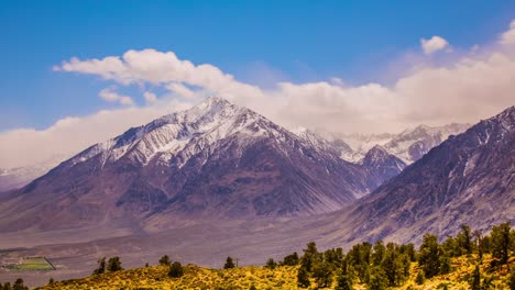 timelapse - clouds moving over snowcapped mountain peaks -4k