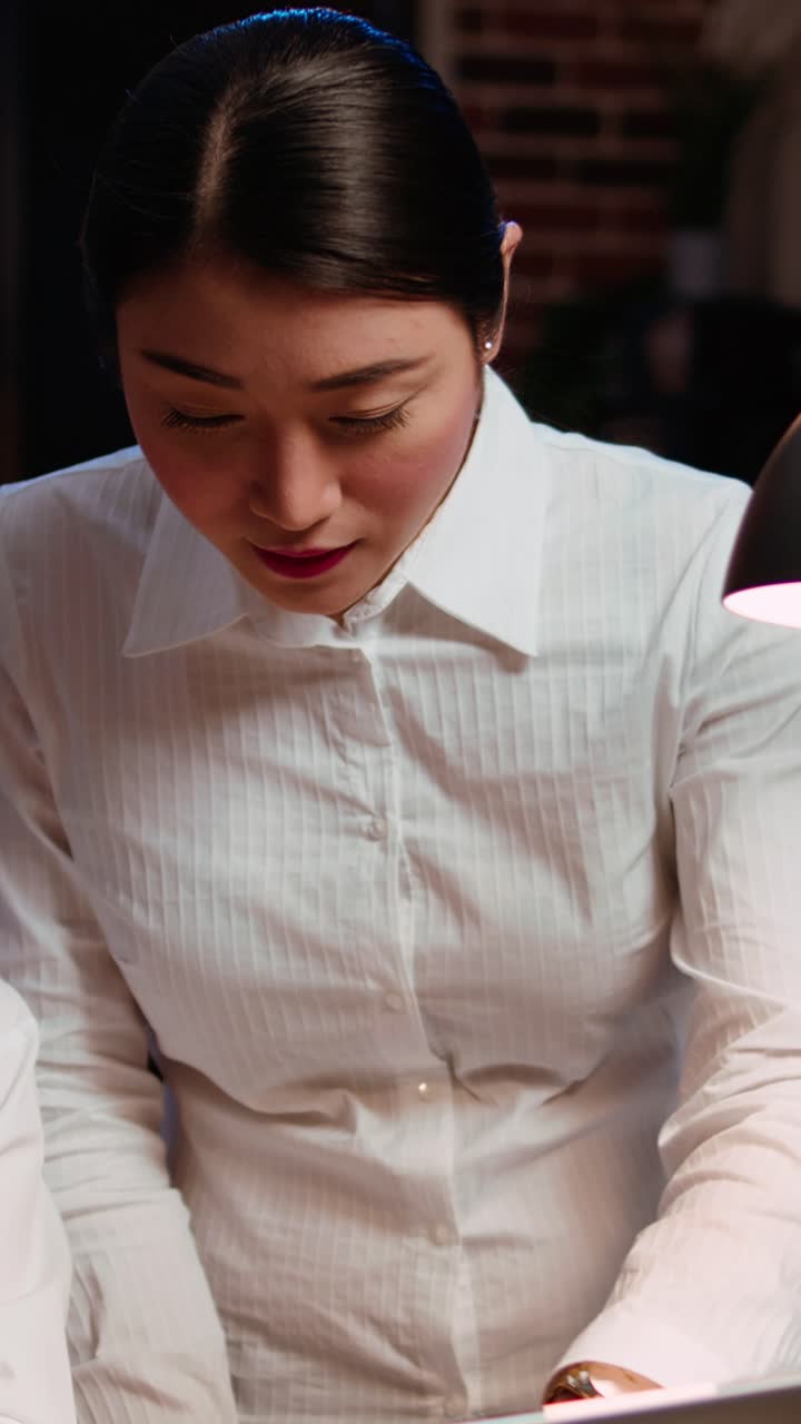 Vertical video Coworkers using laptop to finalize deal with business partners