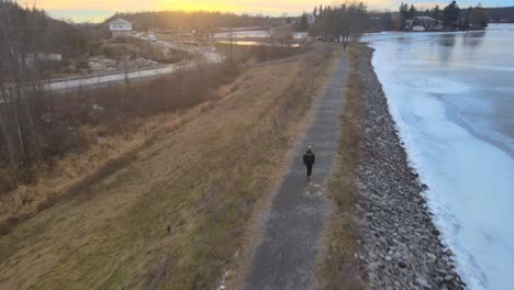 aerial drone following a young woman on a winter day