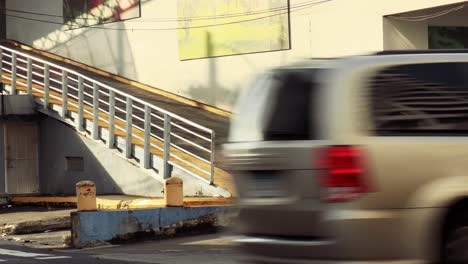 Pedestrian-woman-crossing-the-street-with-some-bags-with-her-mask-on-in-the-City-of-Panama