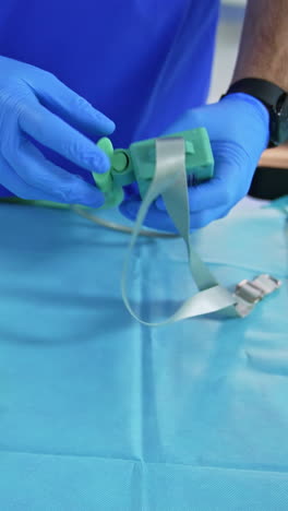 anesthesiologist demonstrating the equipment necessary for his work. doctor stretches the tube from a device describing its usage. vertical video