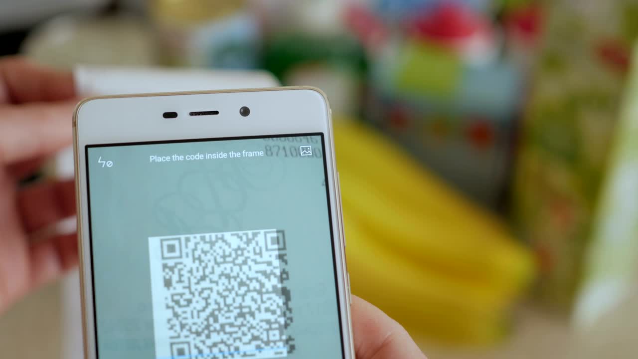 A man scans the QR code on a check from a supermarket.