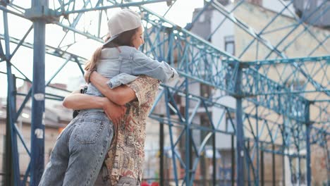 bottom view of hipster happy couple hugging in the street