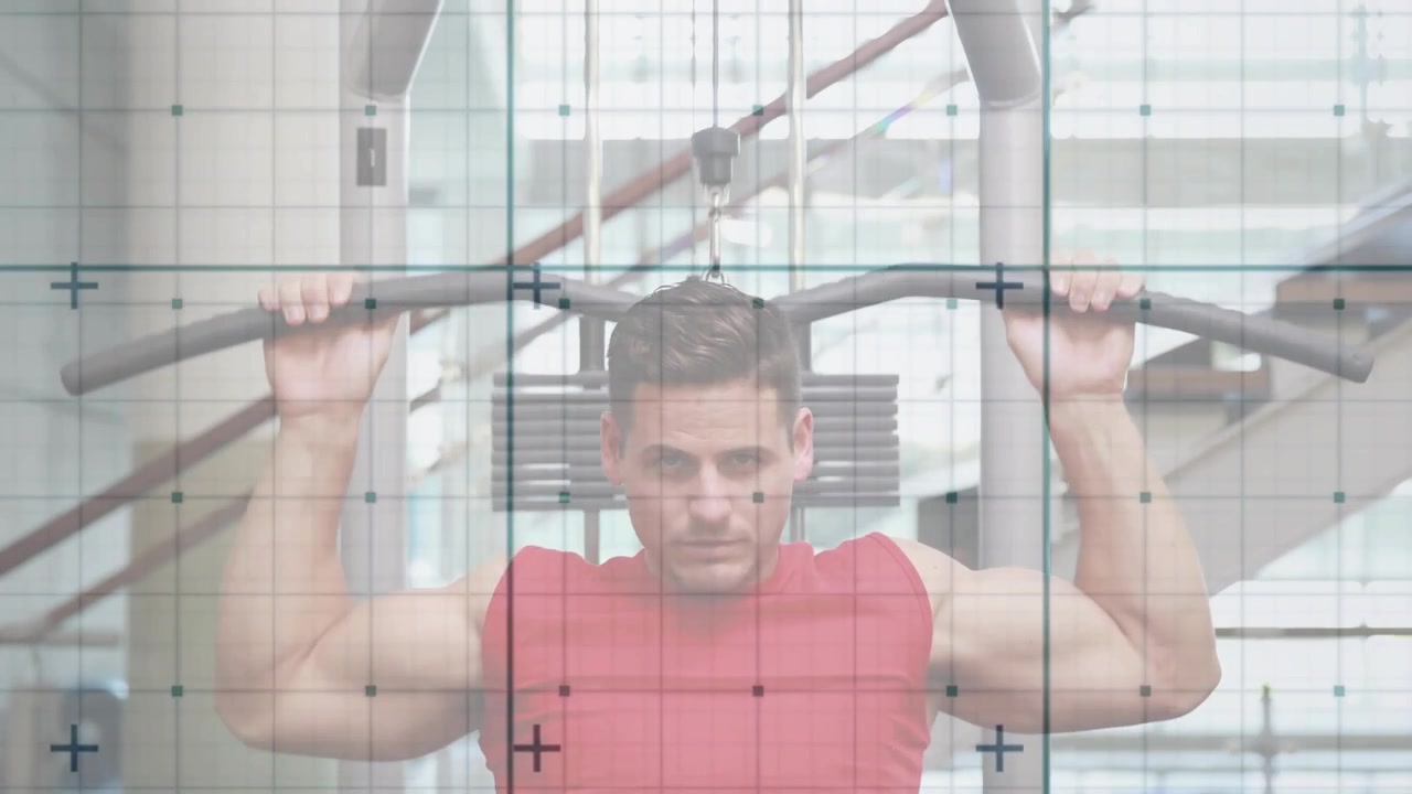 Man gripping lat pulldown bar and performing reps engaging back muscles in fitness gym area